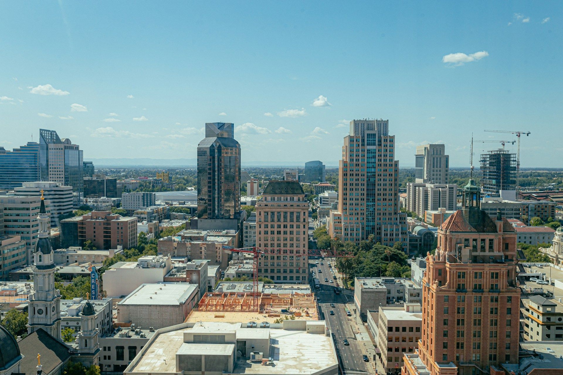 City skyline with tall buildings under a clear blue sky.