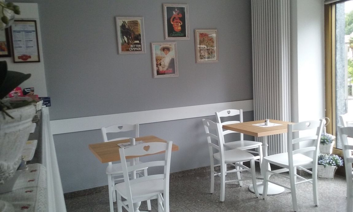 a restaurant with tables and chairs and pictures on the wall