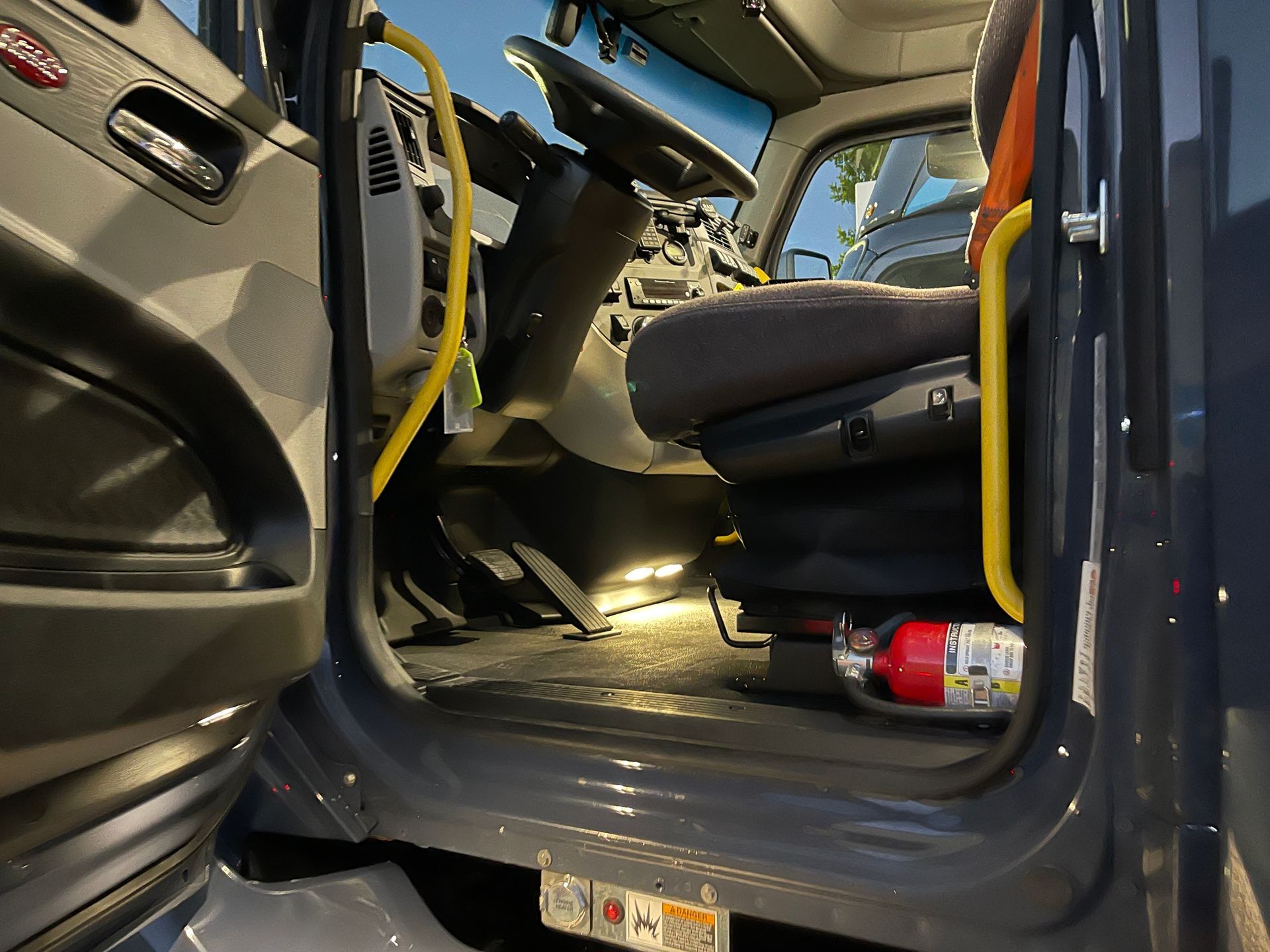 The inside of a truck with a fire extinguisher on the floor