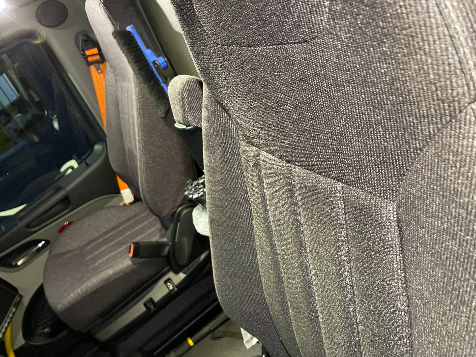 A close up of a car seat with a belt on it