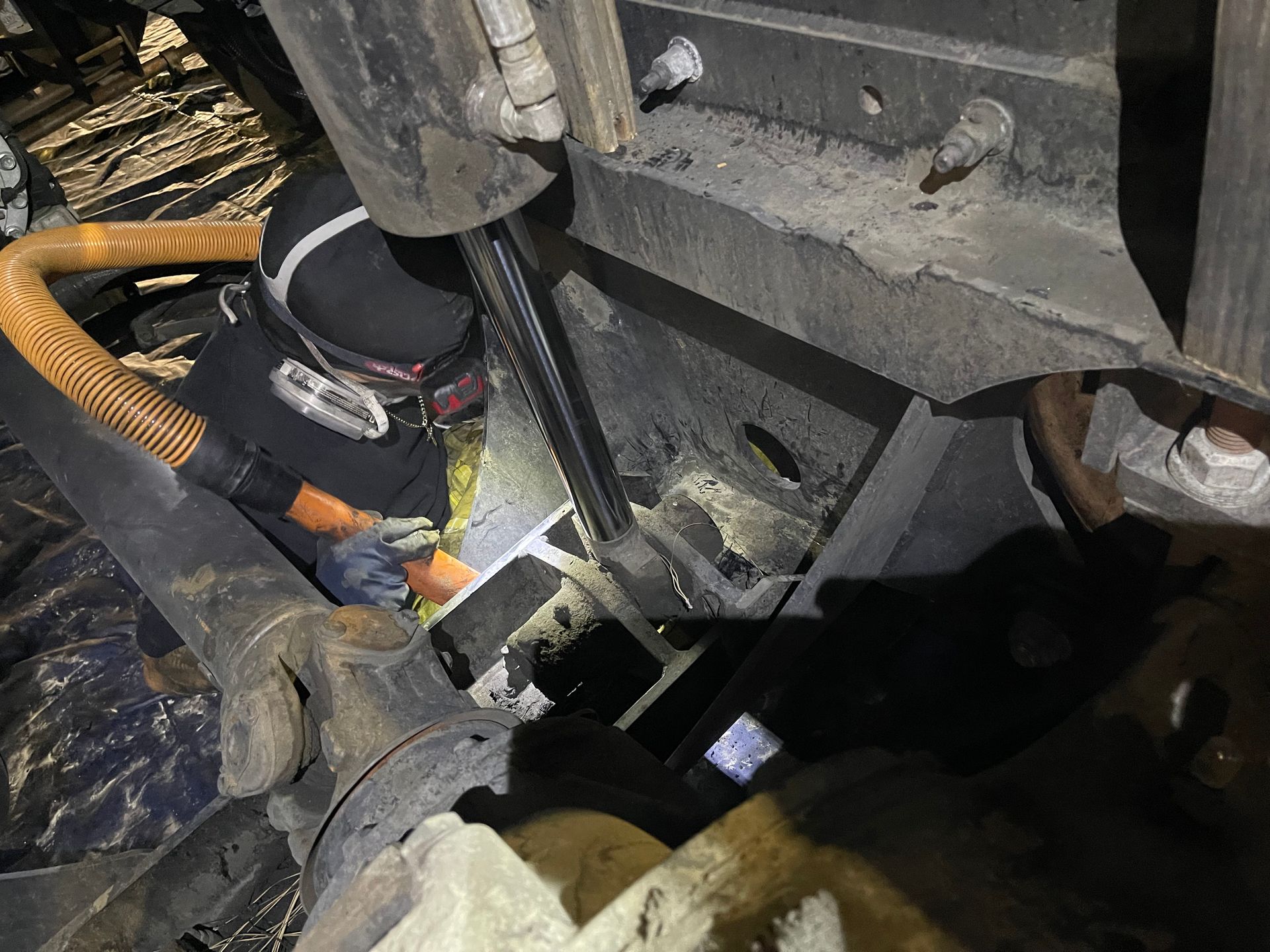 A person is working on a machine in a dark room.