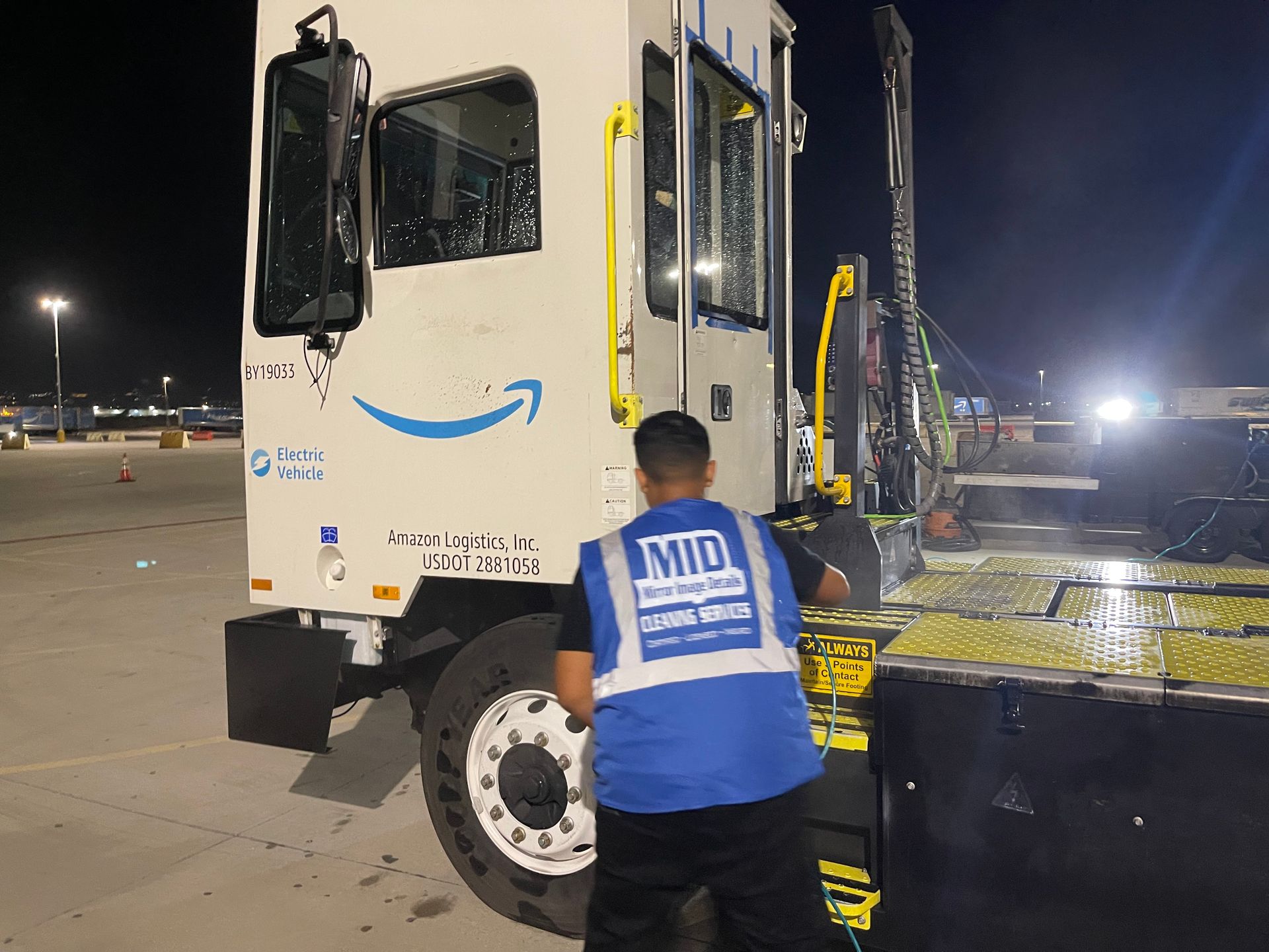 A man wearing a blue vest with the word mid on it
