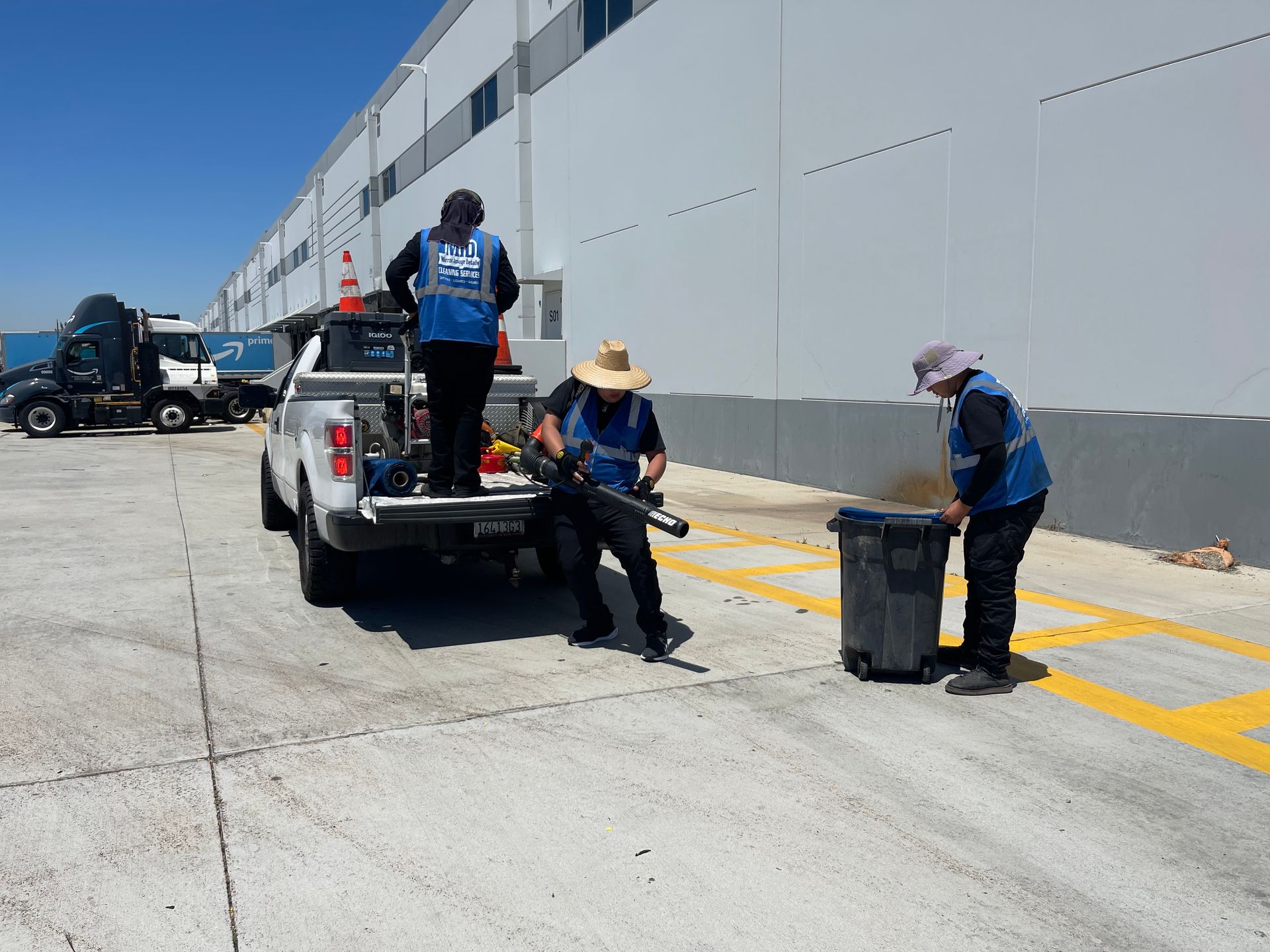 A group of people are standing next to a truck in a parking lot.