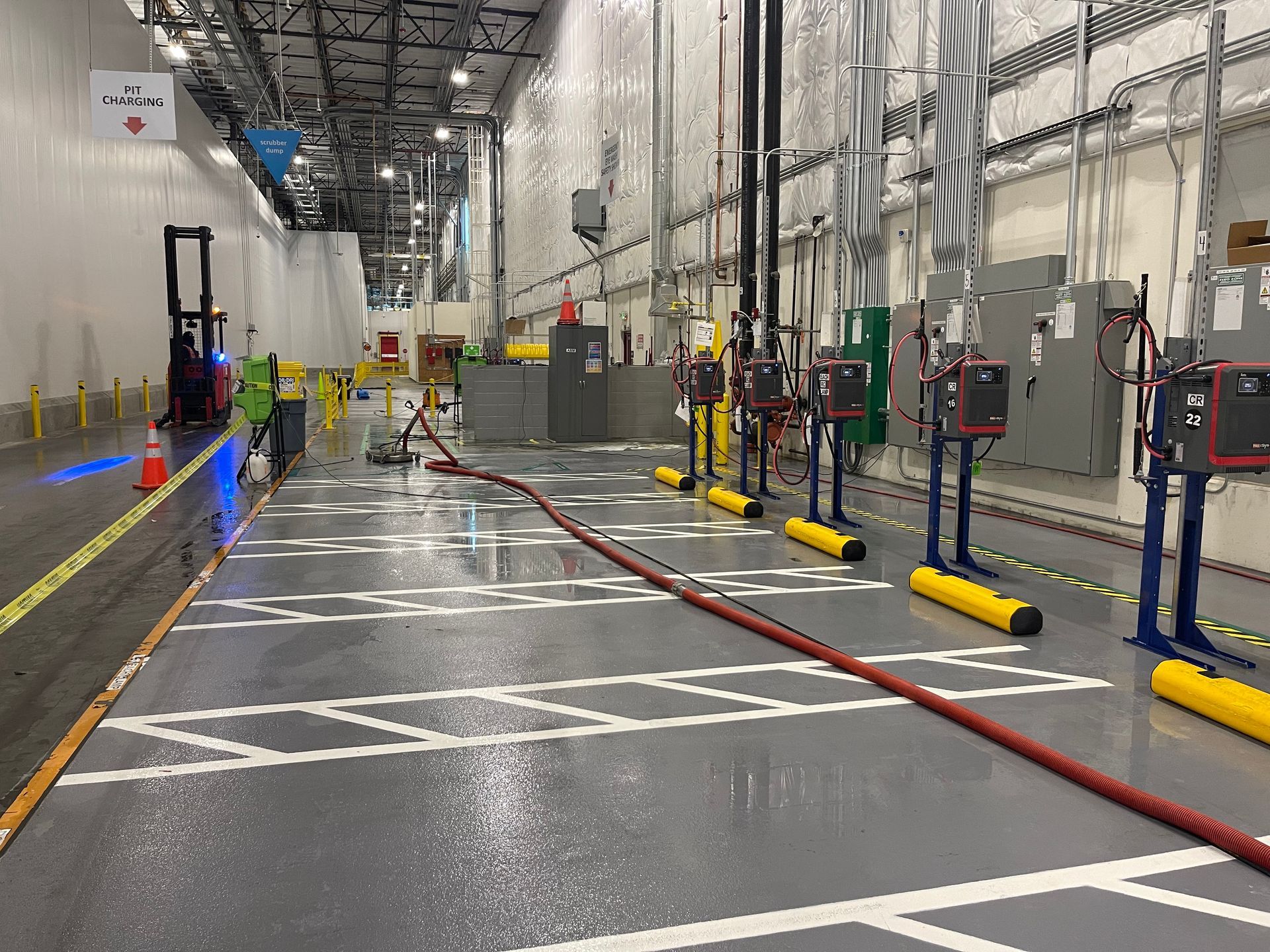 A large warehouse with a lot of electrical equipment on the floor.