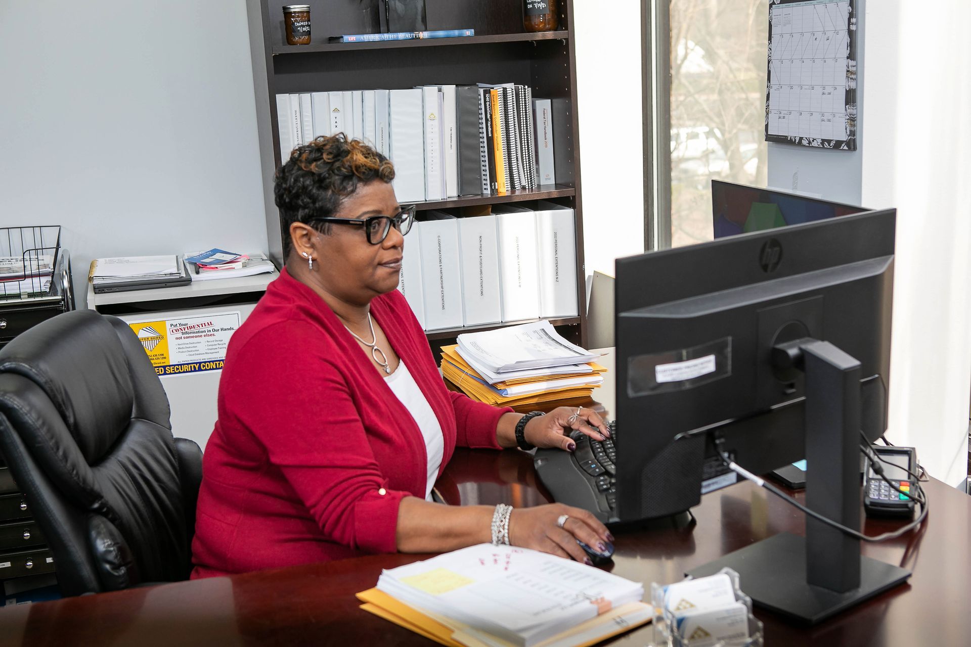 Sonya Beatty, Senior Operation Analyst - EXT. 206  at The Tennie Group LLC, working at her desk in the corporate office. Supporting clients with business accounting, tax services, and financial operations.