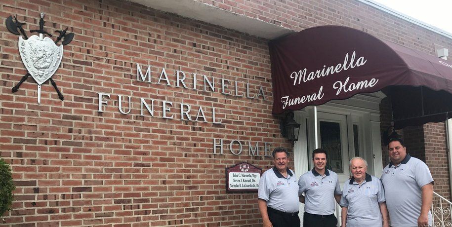 A group of men are standing in front of a funeral home.