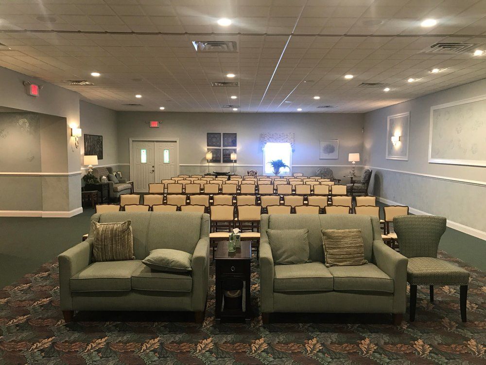 A large room with a lot of chairs and couch.