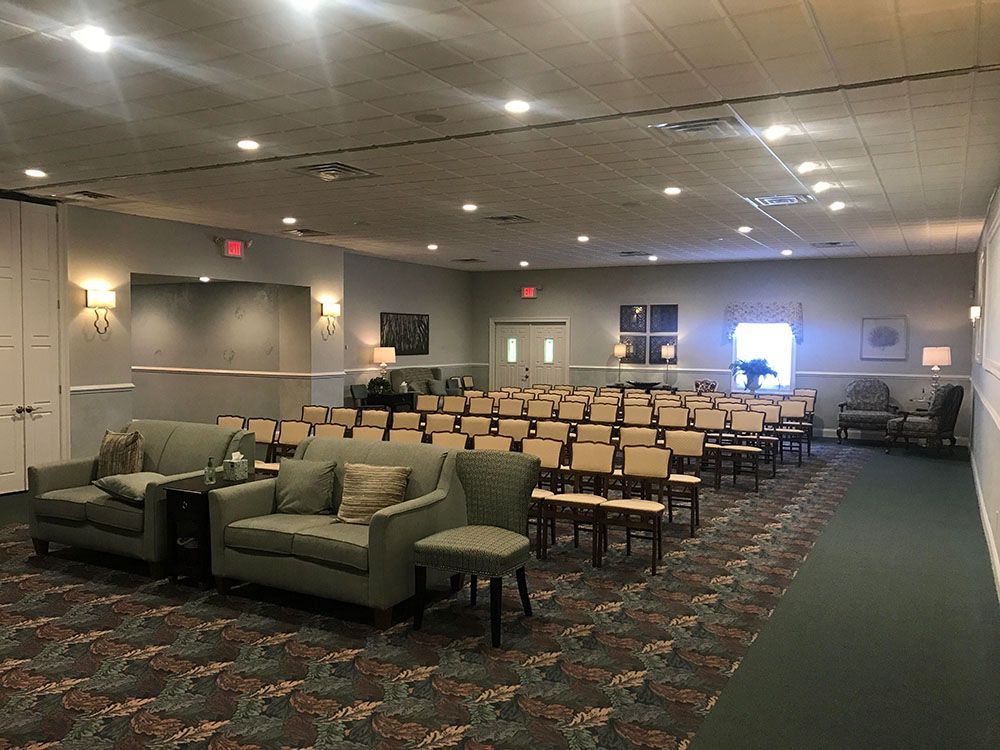 A large room with a lot of chairs and a couch.