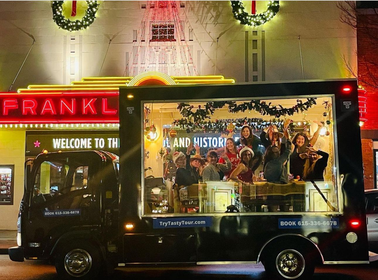 A truck is parked in front of a franklin theater