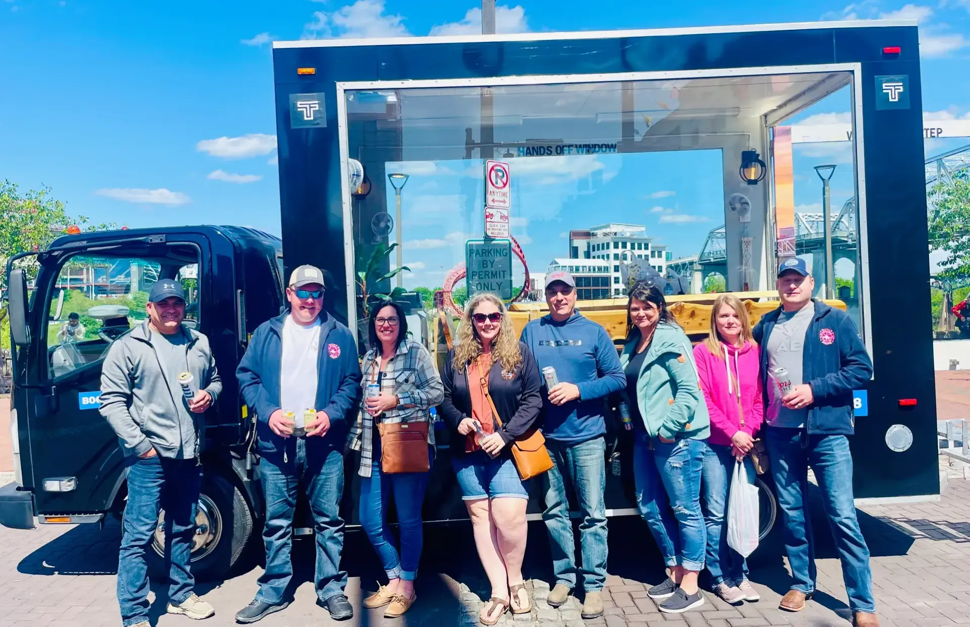 A group of people are standing in front of a food truck.