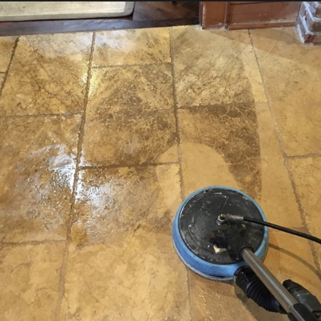 A tile floor is being cleaned with a machine.
