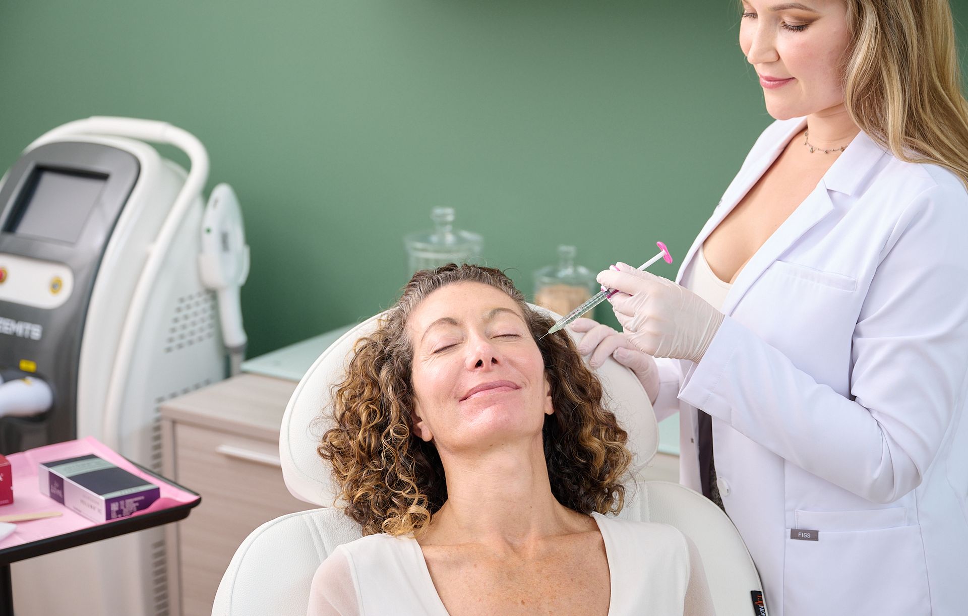 A woman is getting a botox injection in her face.