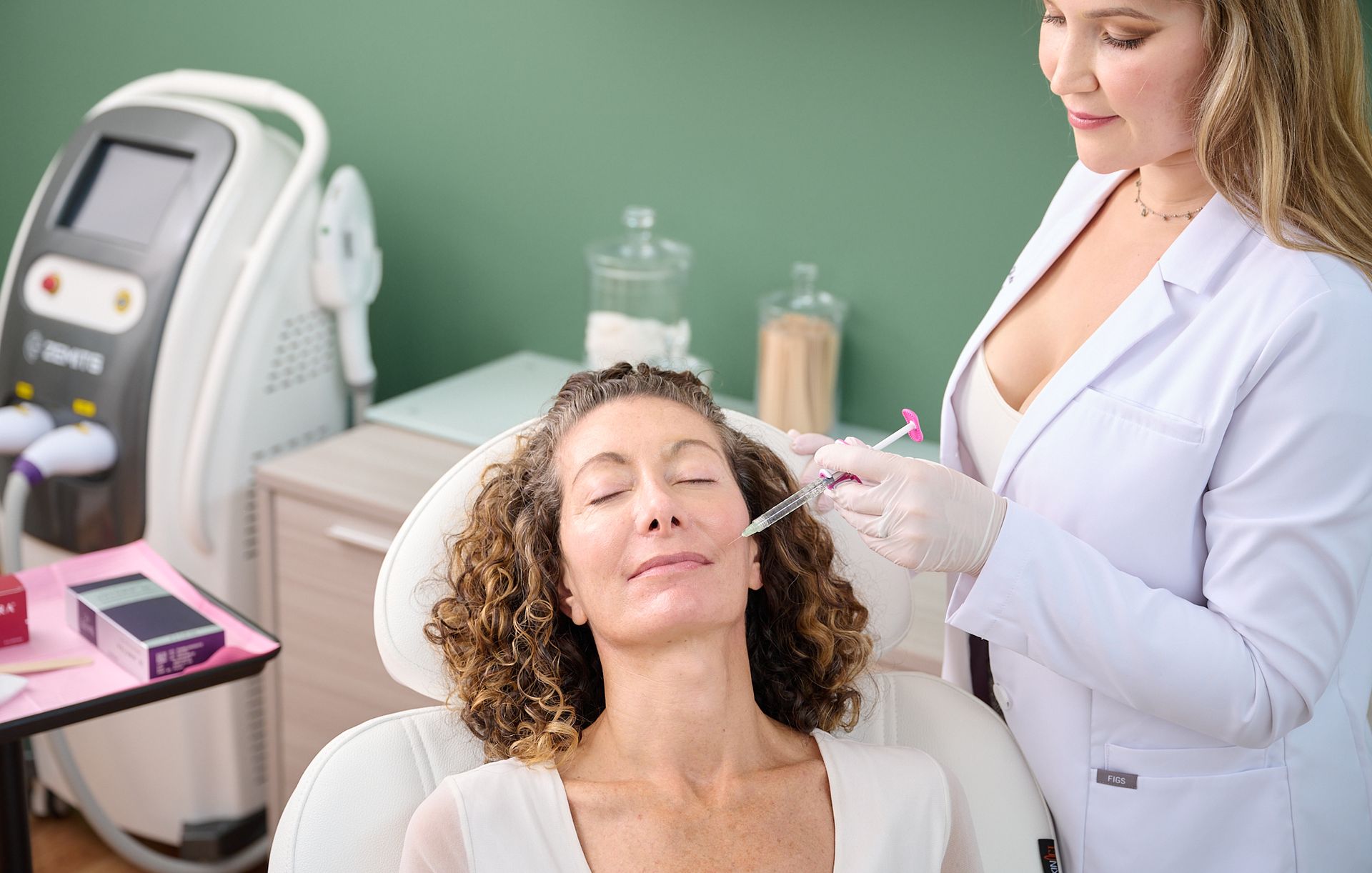 A woman is getting an injection in her face at a beauty salon.