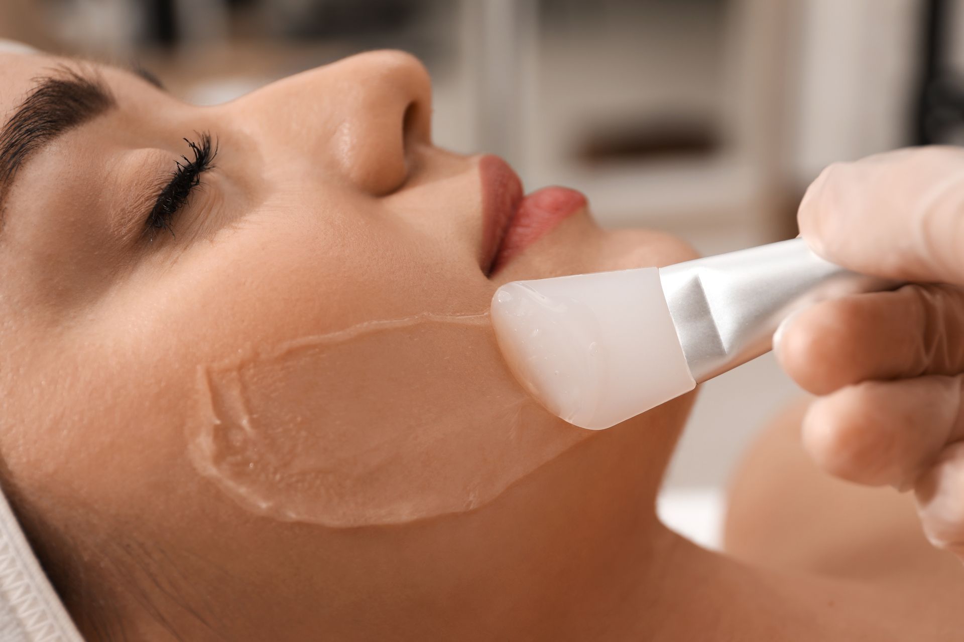 A woman is getting a facial treatment at a spa.