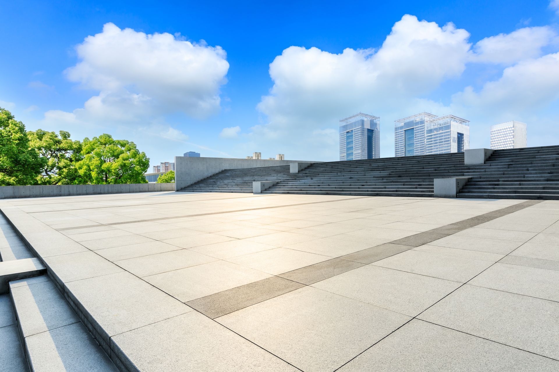 Person kneeling on a roof, using a torch to install roofing material.