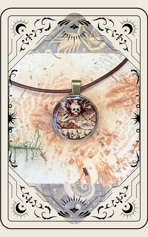 Round pendant with skull design on brown cord, set against a patterned background in a decorative frame.