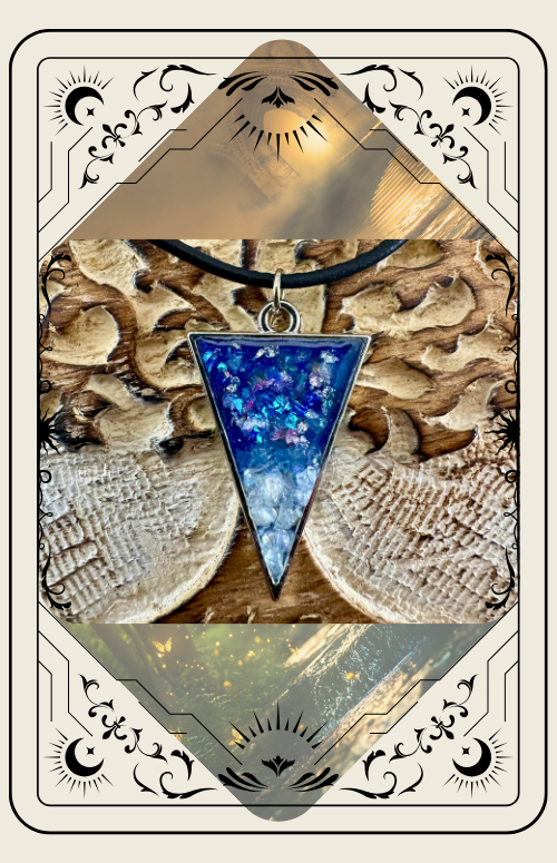 Triangular blue and white pendant necklace on a wooden background, set in an ornate cream-colored frame.