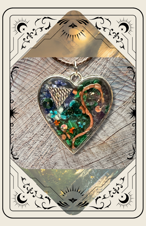A heart-shaped pendant filled with green crystals and copper wire, presented on a decorative card with a celestial border.