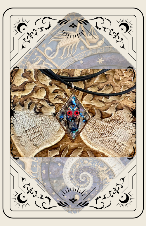A pendant with red and blue jewels on a black cord, set on a honeycomb background, in a tarot card frame.