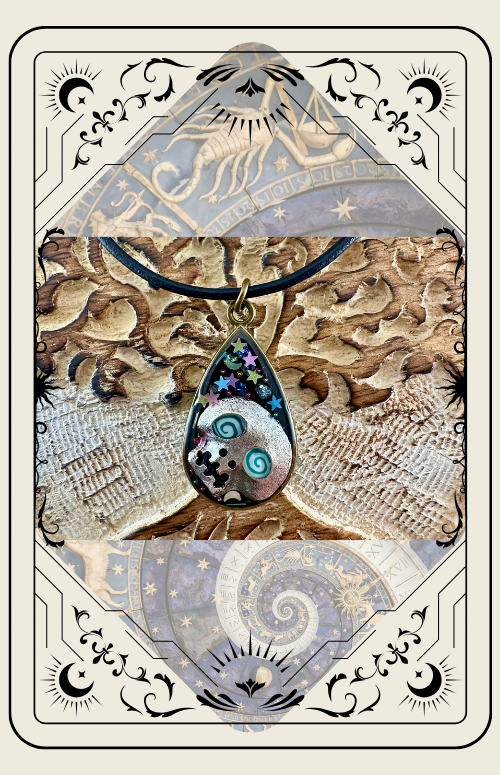Teardrop pendant necklace with swirling design, stars, and crescent moons. Beige border with celestial details.