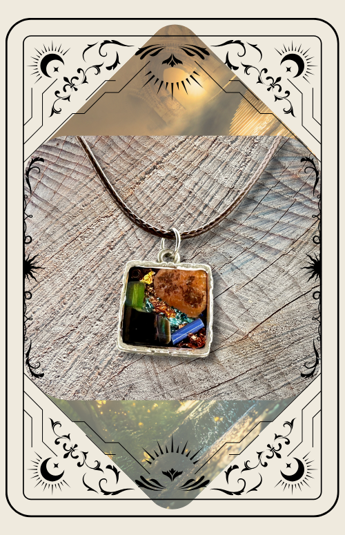 A square pendant featuring colorful, textured fragments set in resin, hanging on a cord against a wood background.