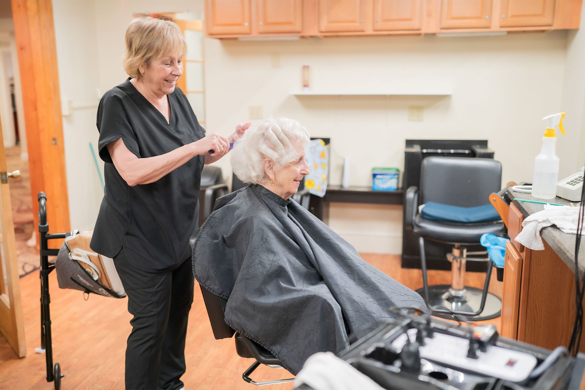 A group of elderly people are sitting at tables in a dining room.