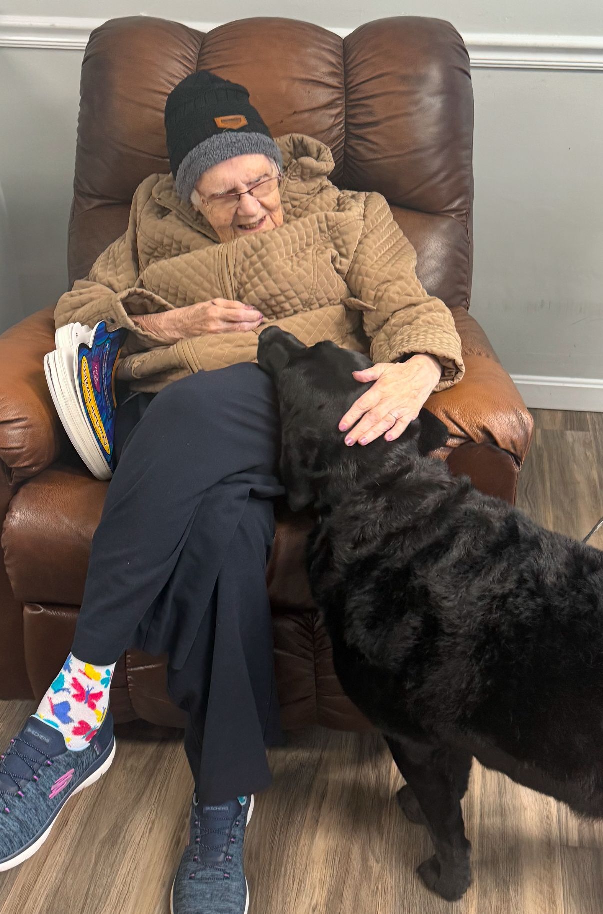 A group of people in wheelchairs are sitting in a circle in a room.