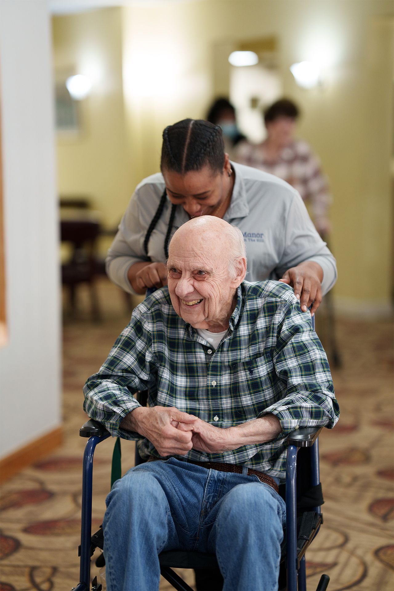 A group of elderly women are sitting in chairs in a room.
