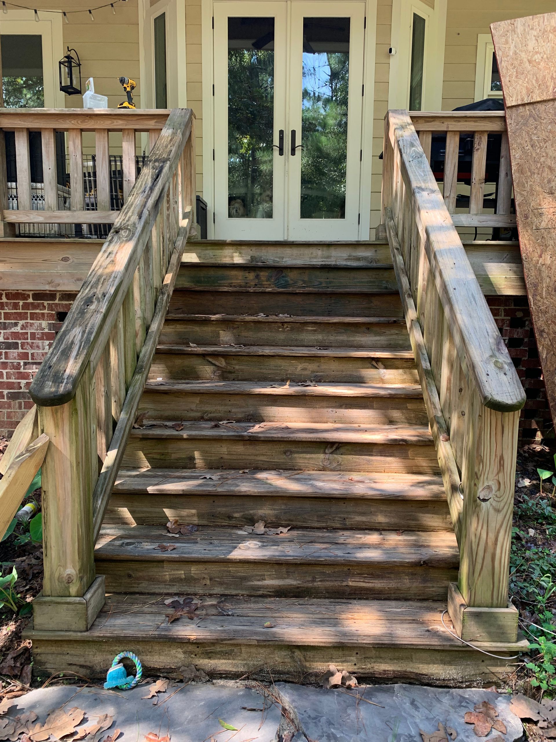 A set of wooden stairs leading up to a house.