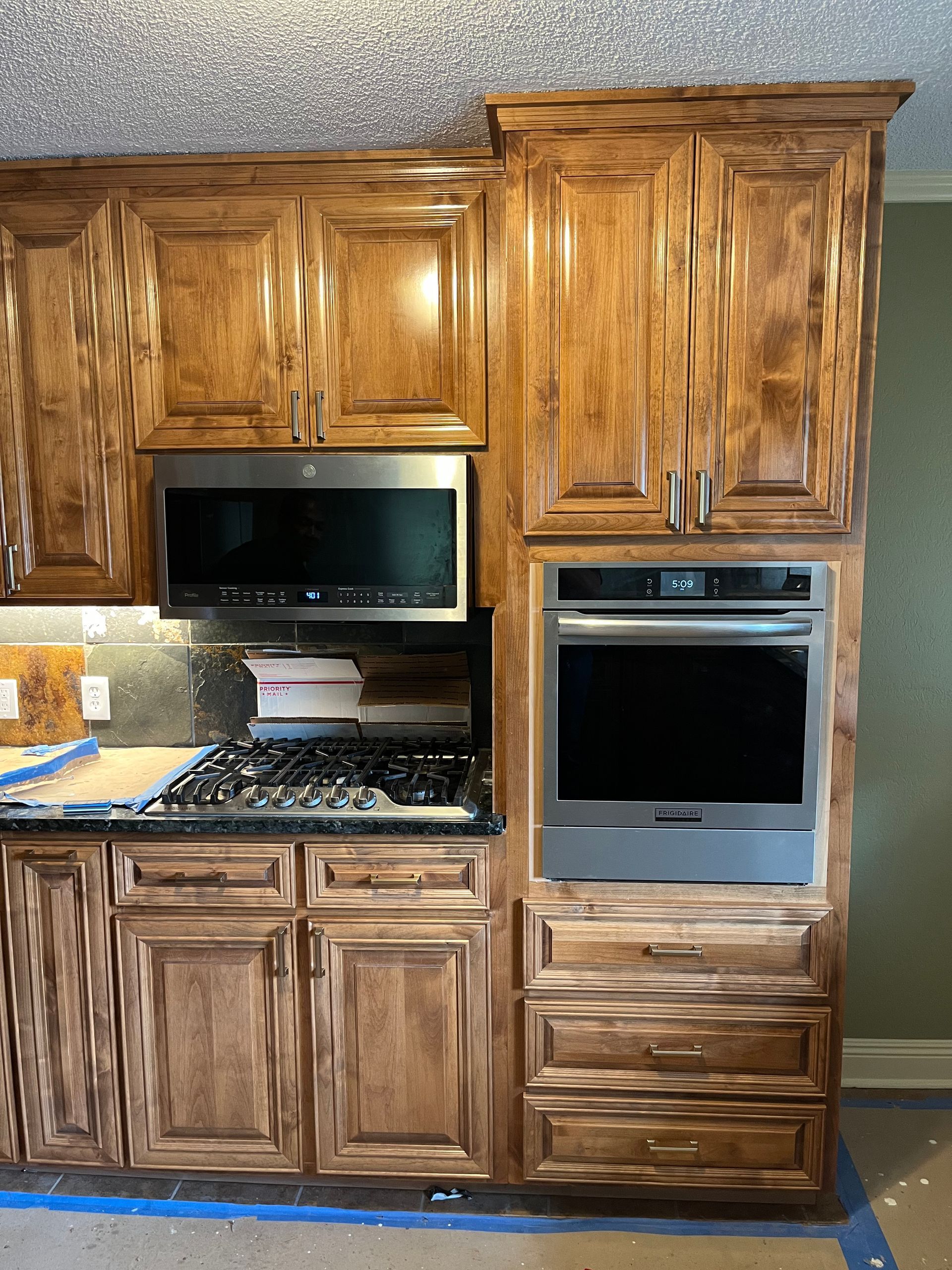 A kitchen with wooden cabinets and stainless steel appliances