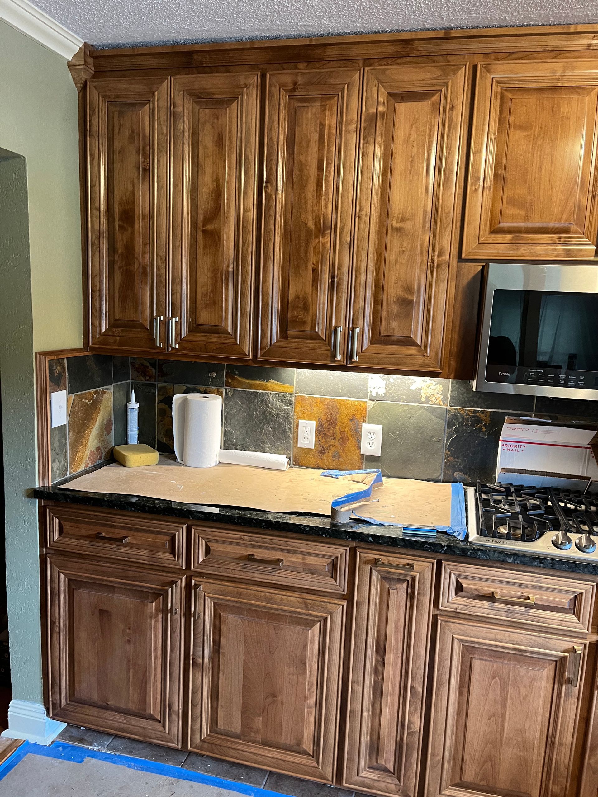 A kitchen with wooden cabinets and a stove top oven
