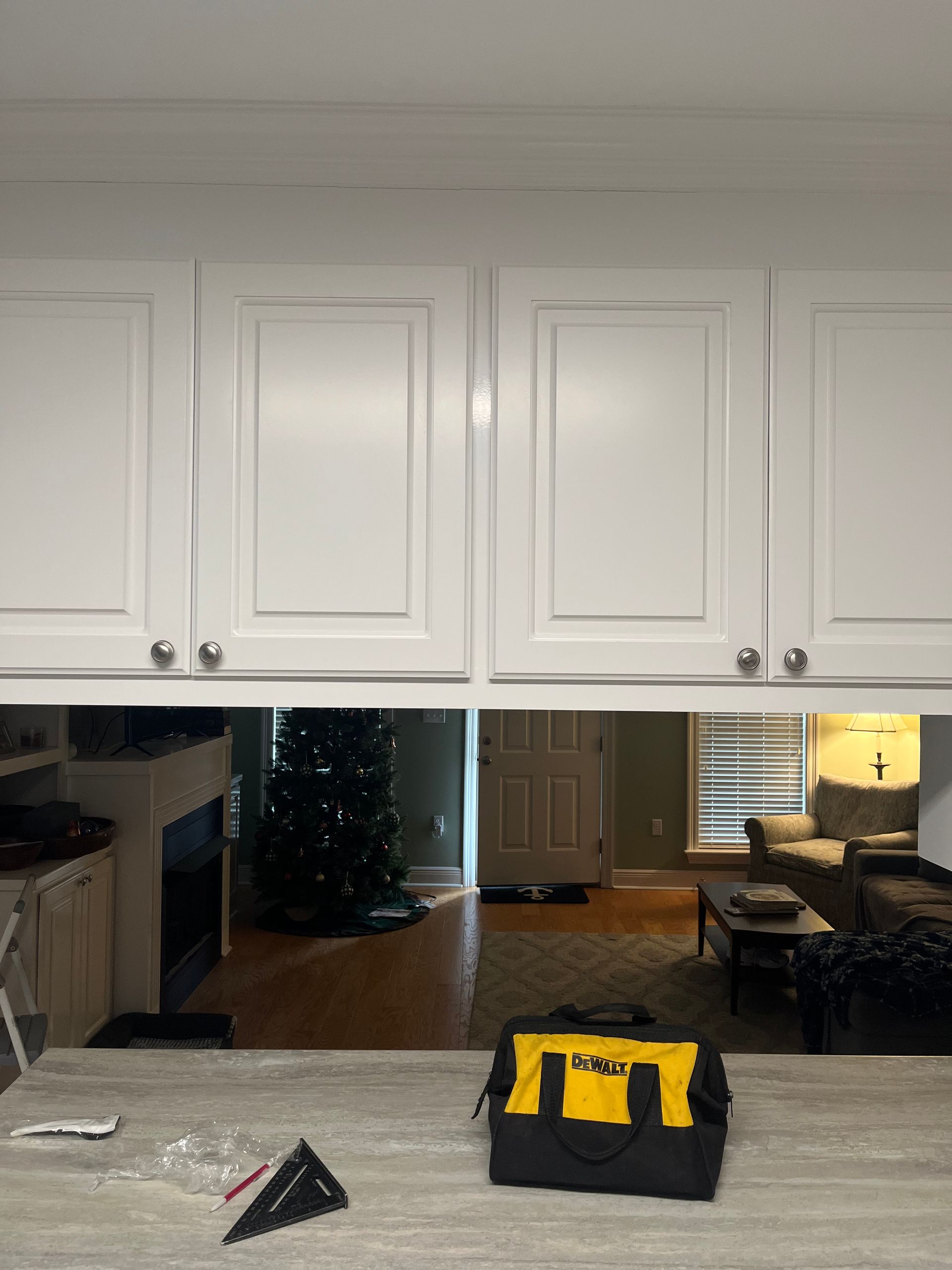 A black and yellow tool bag is sitting on a counter in a kitchen.