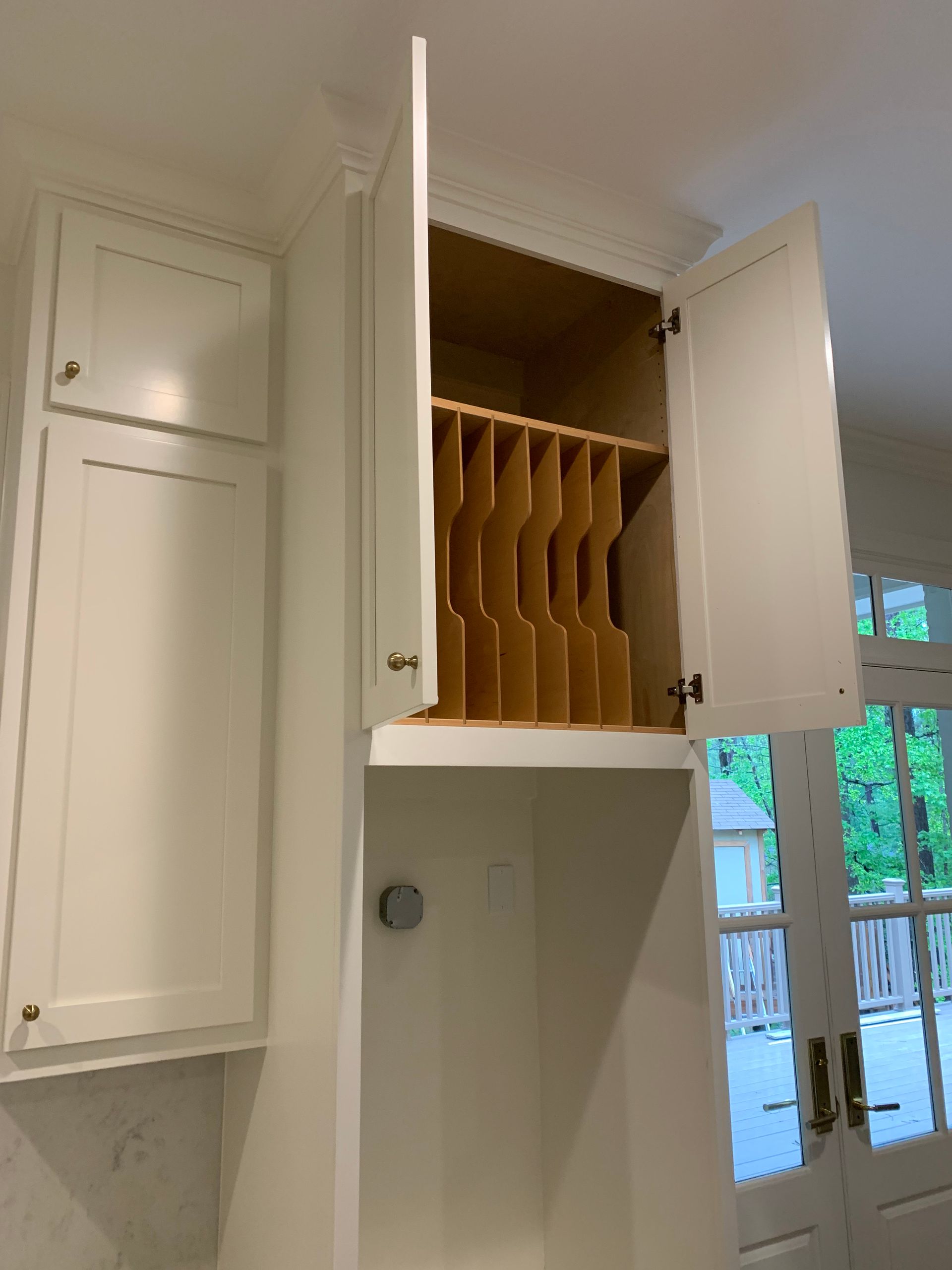 A white cabinet with a wooden shelf inside of it