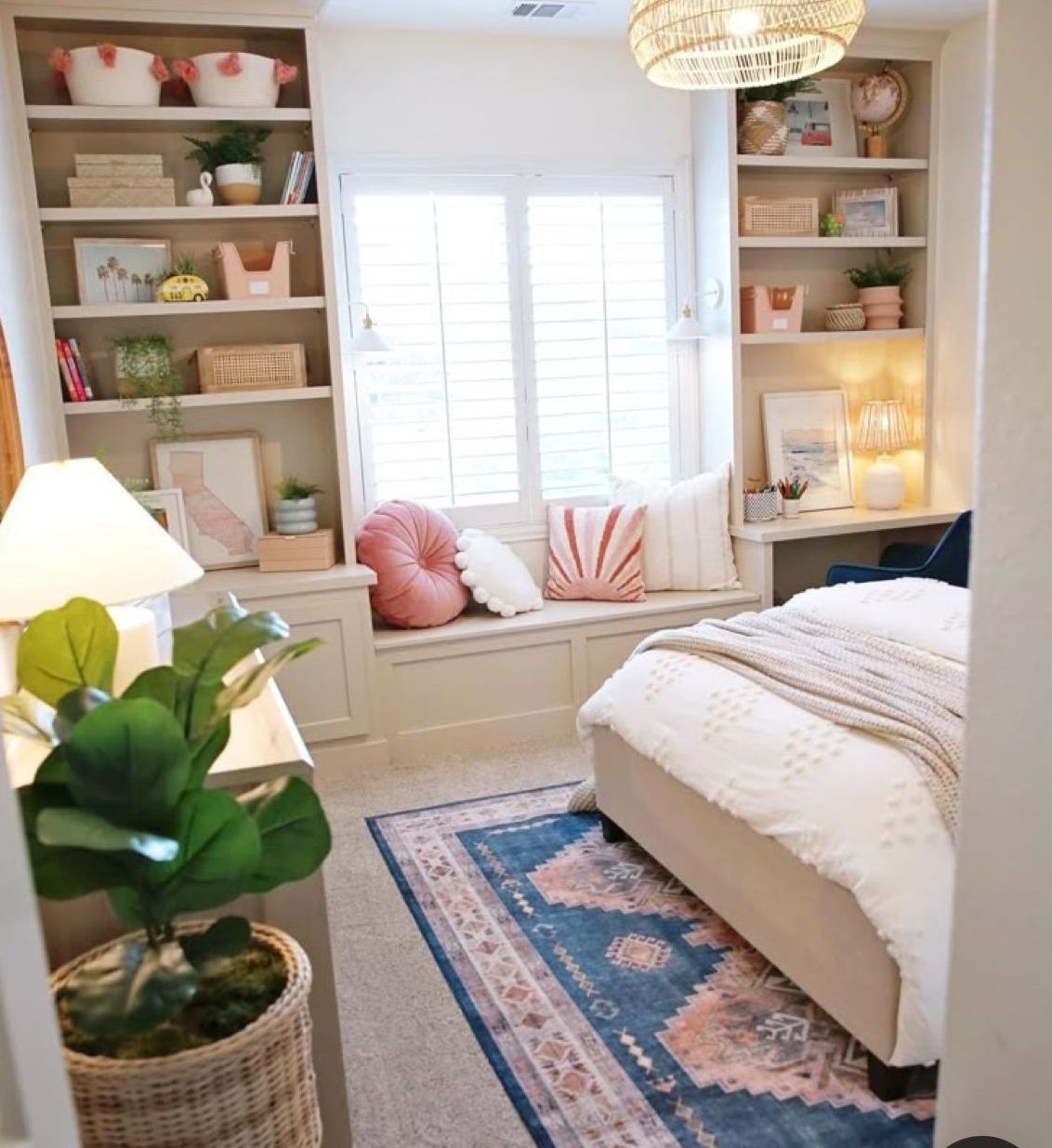 A bedroom with a bed and a window seat