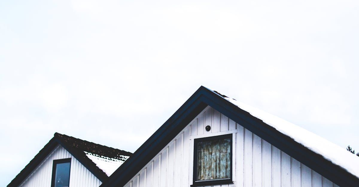 A white house with a black roof and a window