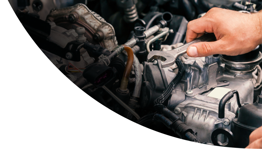 A person is working on a car engine with a wrench | Dacey Place