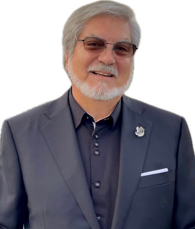 A man with a beard wearing a suit and glasses