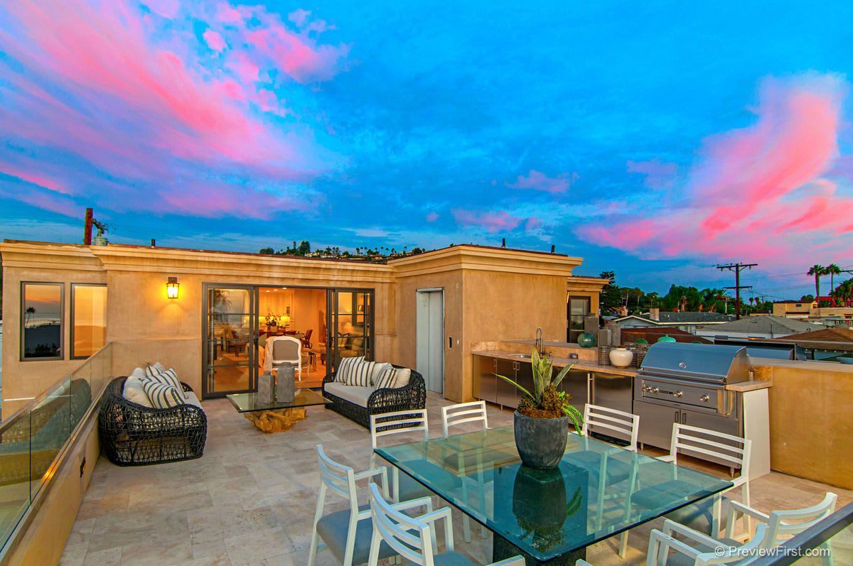 There is a patio with a table and chairs on it.