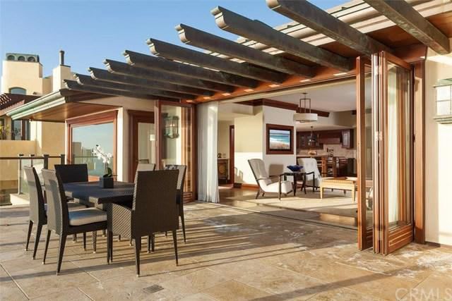 A patio with a table and chairs under a pergola.