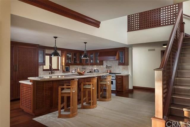A kitchen with a staircase leading up to the second floor.