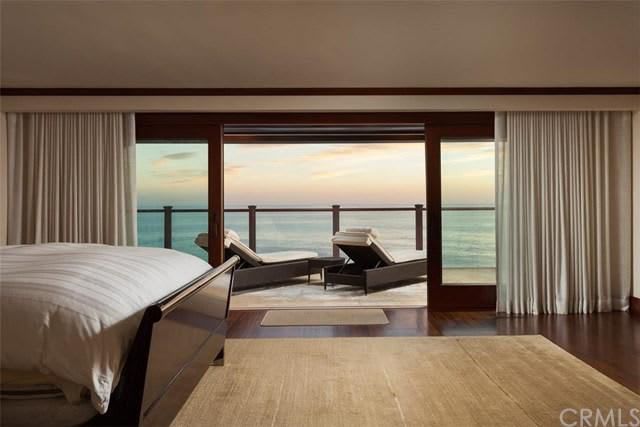 A bedroom with a bed and a view of the ocean.