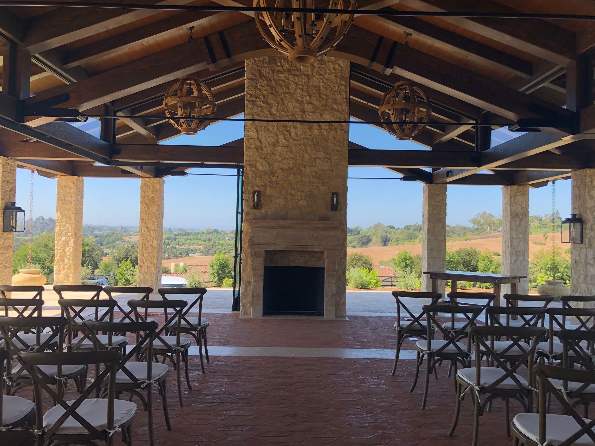 A row of chairs are lined up in a room with a fireplace.