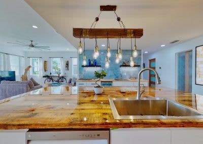 A kitchen with a sink and a wooden counter top.