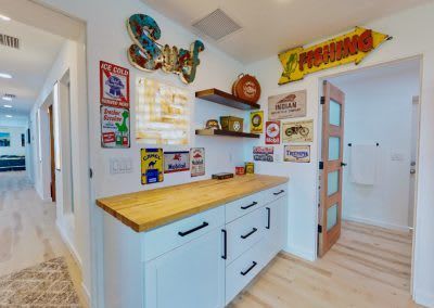 A kitchen with a wooden counter top and a sign on the wall.