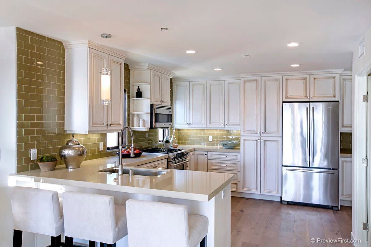 A kitchen with white cabinets and stainless steel appliances.