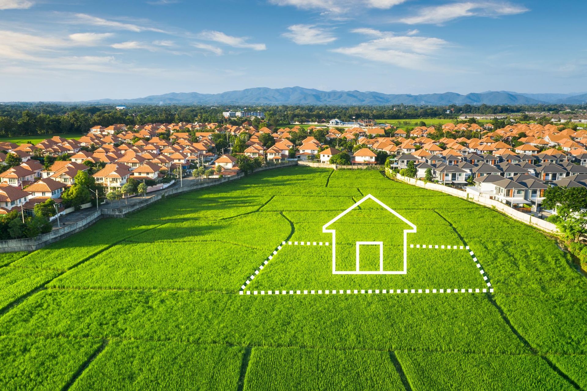 A white outline of a house sits on a lush green field, surrounded by a residential neighborhood under a blue sky.