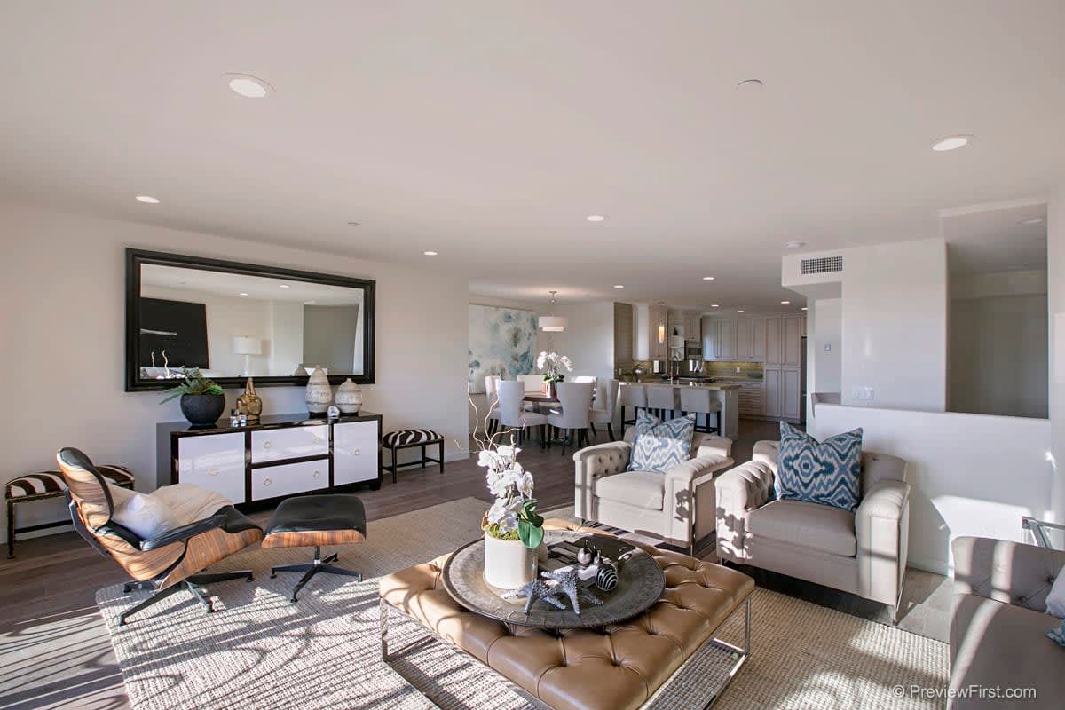 A living room filled with furniture and a large mirror.