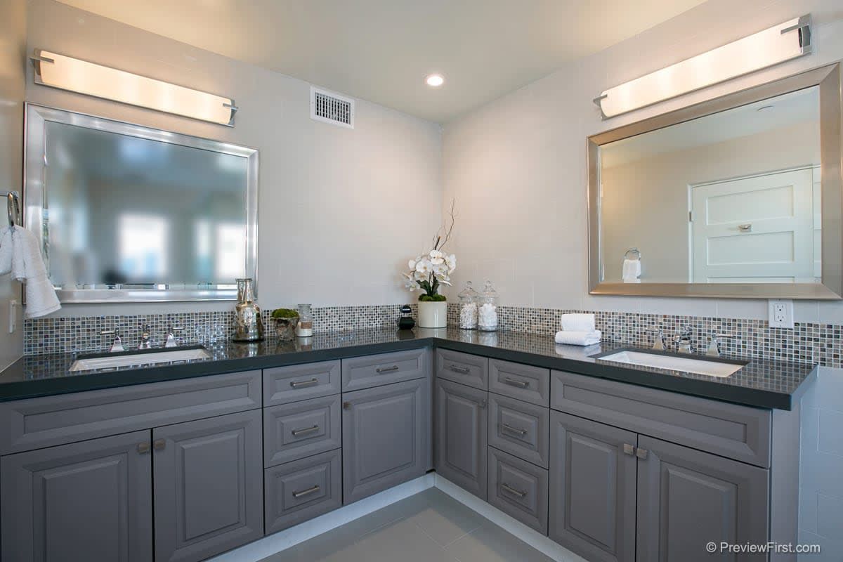 A bathroom with two sinks and two mirrors.