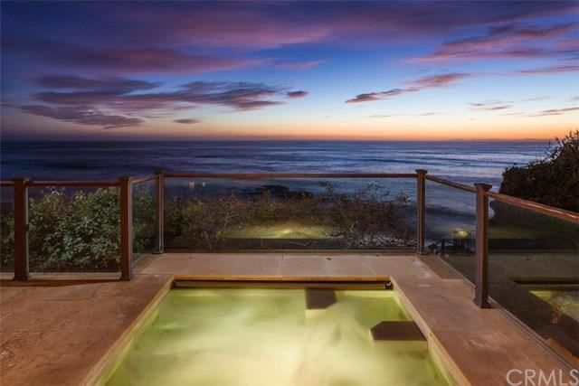 There is a hot tub with a view of the ocean.