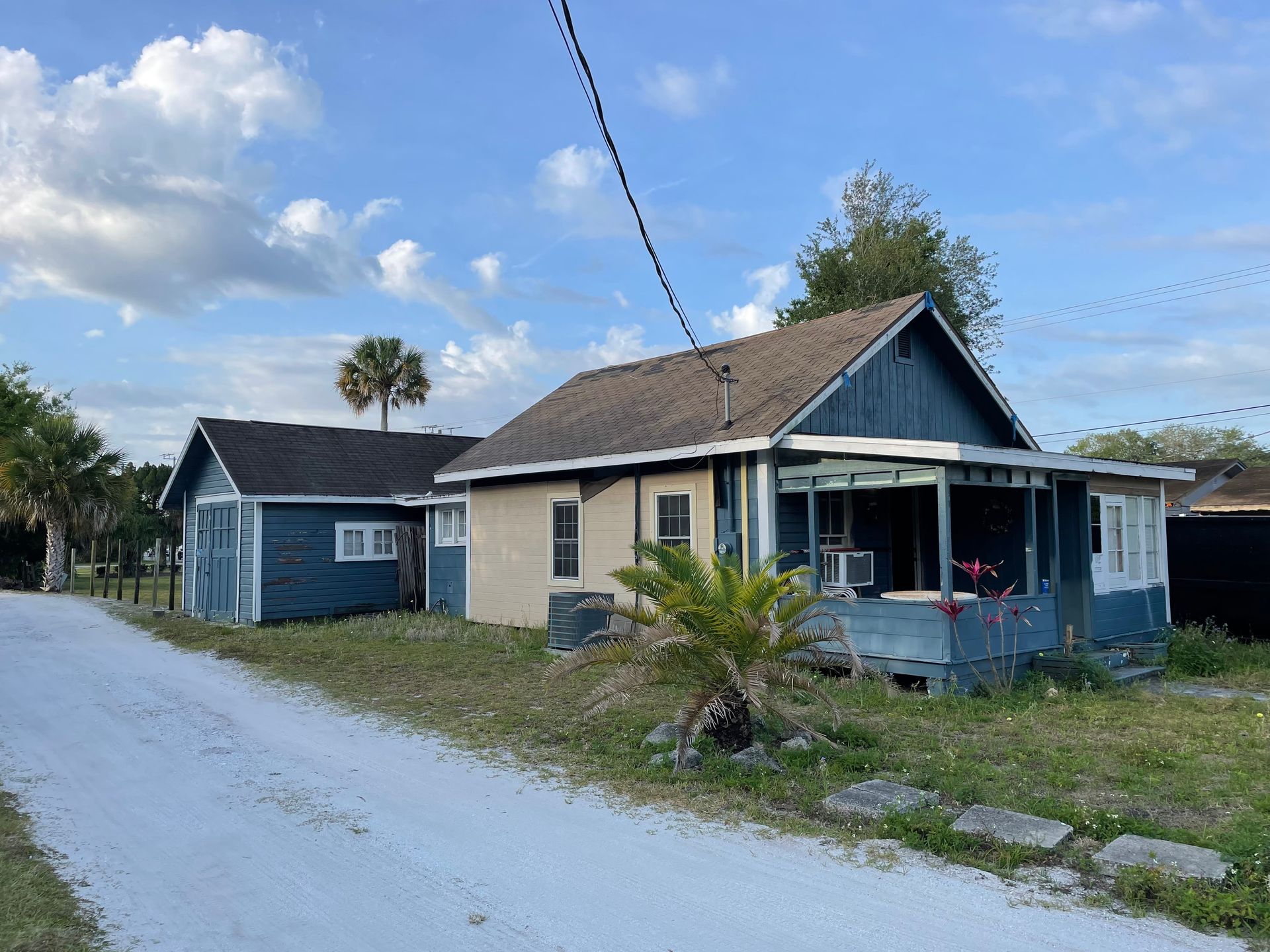 A man is sitting on the stairs leading to the beach.